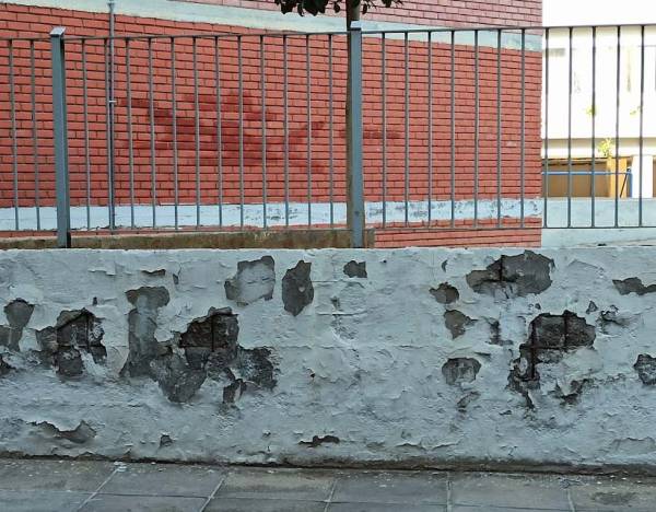 Σκουριασμένα σίδερα σε τοίχο σχολείου